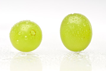 Two wet green grapes isolated on white background