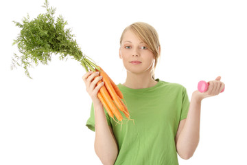 Fitness young woman and carrots