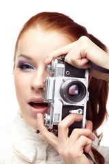 Beautiful young  woman with camera...