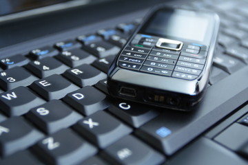 Obraz premium Cell phone and laptop as a business concept