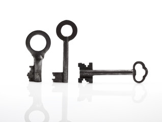 Three  Old keys over a white background