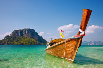 Boat and rock near tropical island