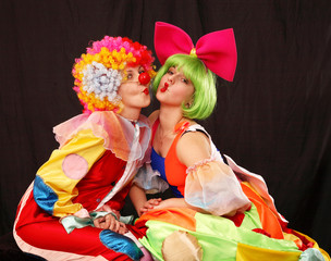 A portrait of two clown-girls in wigs