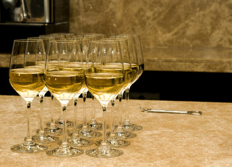 Glasses with white wine and opener on marble