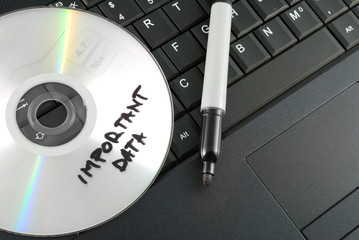 Important data disk on laptop keyboard concept.