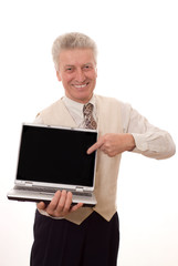 Senior man holding a laptop with blank screen where you can writ