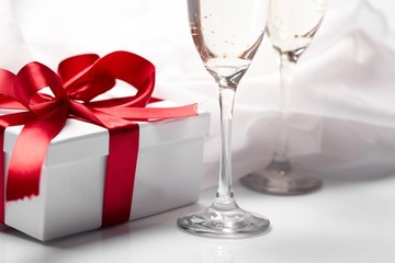 Gift decorated with bow, glass wine