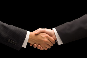 Executives handshake against a black background