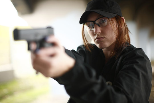 Woman aiming pistol