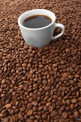 Cup with coffee, costing on coffee grain