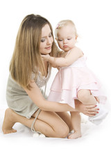 Careful mother dresses her daughter