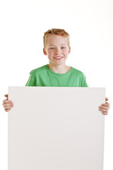 Happy boy with the empty blank sign isolated on white