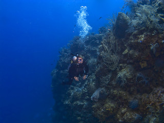 Female Diver off the wall in Cayman Brac