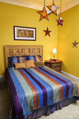 Bedroom Interior With Striped Bedspread and Decorative Stars