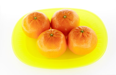 Tangerines on yellow plate