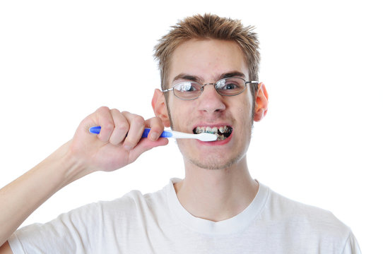 Young adult man brushes teeth