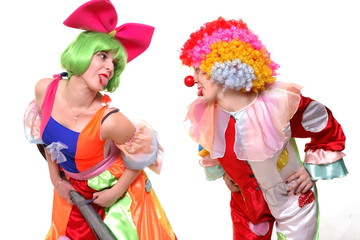 A portrait of two clown-girls in bright costumes