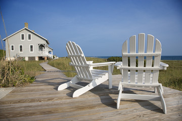 Chairs on Deck Facing Ocean - obrazy, fototapety, plakaty