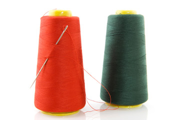 two bobbins with threads