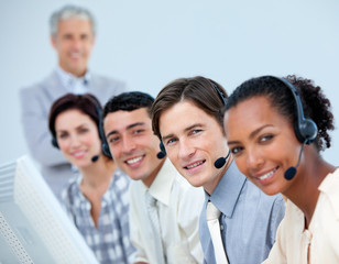 Fototapeta premium Cheerful business team working in a call center