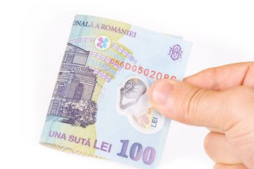 Hand holding 100 RON bill isolated on white