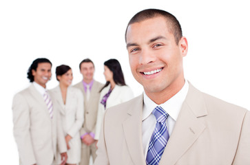 Happy businessman standing in front of his team