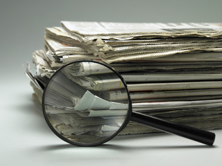 stack of paper and magnifier