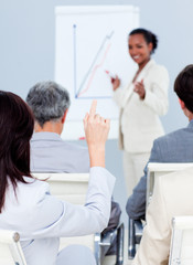 Young businesswoman asking a question at a conference