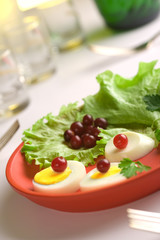 Served egg  salad on a red round dish