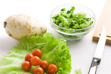 Fresh vegetables for salad over white background