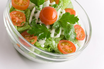 Vegetables salad in a glass salad bowl