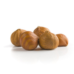 Pile of peeled hazelnuts over white background