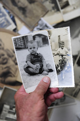 childhood: man holding photo of himself as a boy