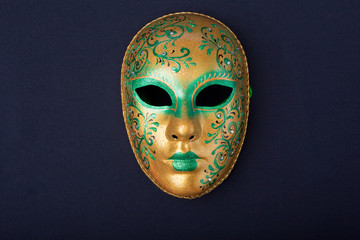 green and gold mask isolated on a black background