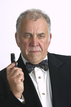 Older Man With A Gun And In A Tuxedo