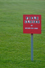 Field Closed sign in a grass field
