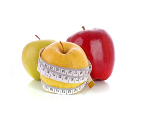 Fresh apples with a measuring tape