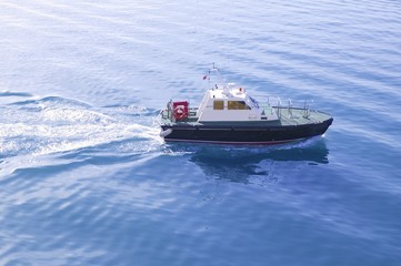 Blue Mediterranean Sea with pilots boat