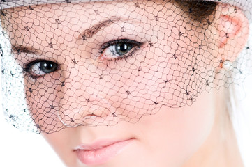 Closeup portrait of young lady in veil in high key