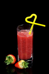 fresh strawberry and juice on black background
