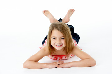 Young Girl Lying On Stomach In Studio