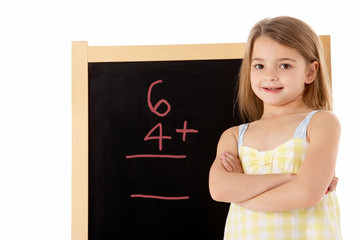 Young Girl Looking Thoughtful Next To Blackboard