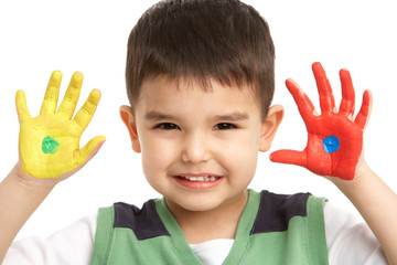 Studio Portrait Of Young Boy With Painted Hands