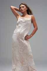 Full Length Studio Shot Of Young Woman In White Evening Dress