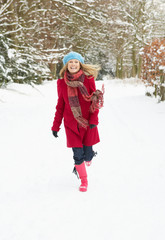 Woman Running Through Snowy Woodland