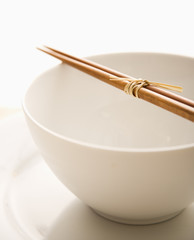 Chopsticks on an Empty Bowl. Isolated