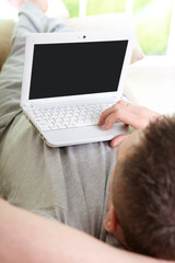 Man using laptop in home