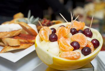 Melon stuffed with melon pieces, tangerine and grapes