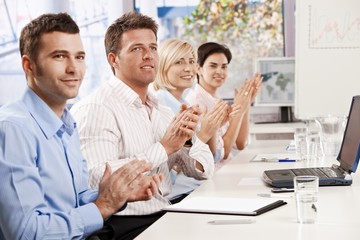 Business people clapping at meeting