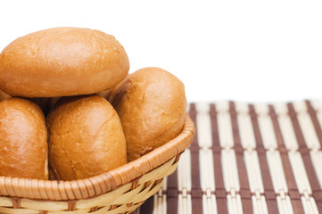 Rolls in a wattled basket isolated on white